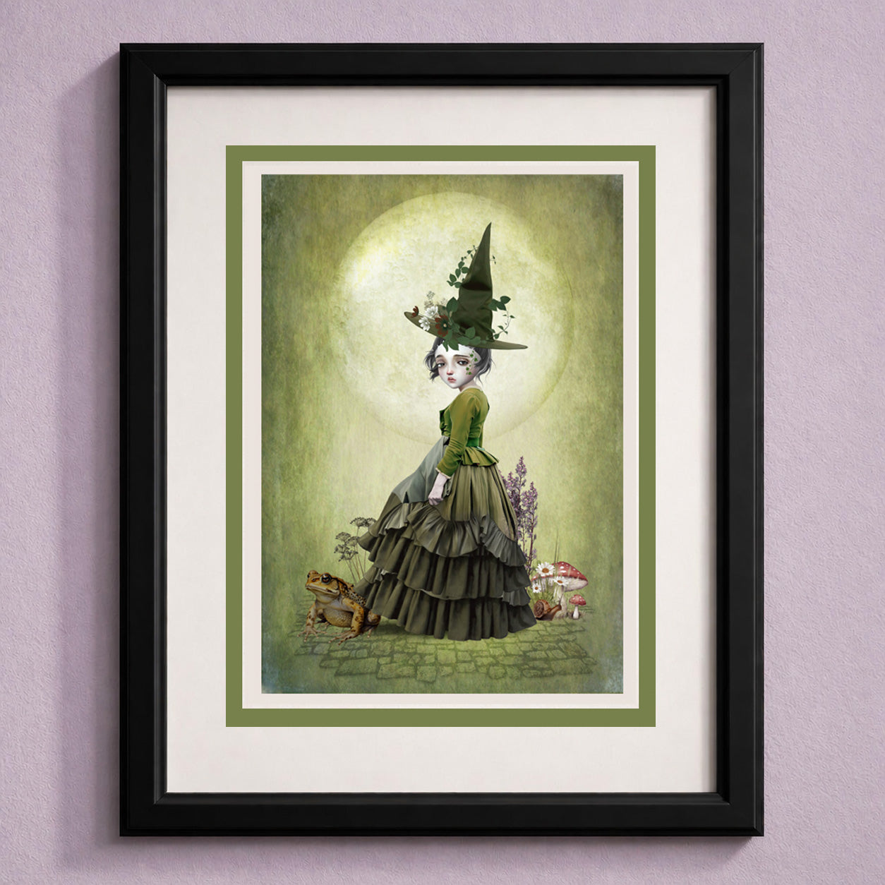 Green witch and toad art greeting card with a dark whimsical fantasy aesthetic. Inside a frame for display