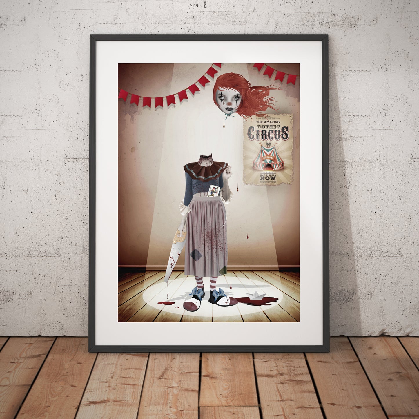 Headless Clown art print in a black frame, standing against a white wall.