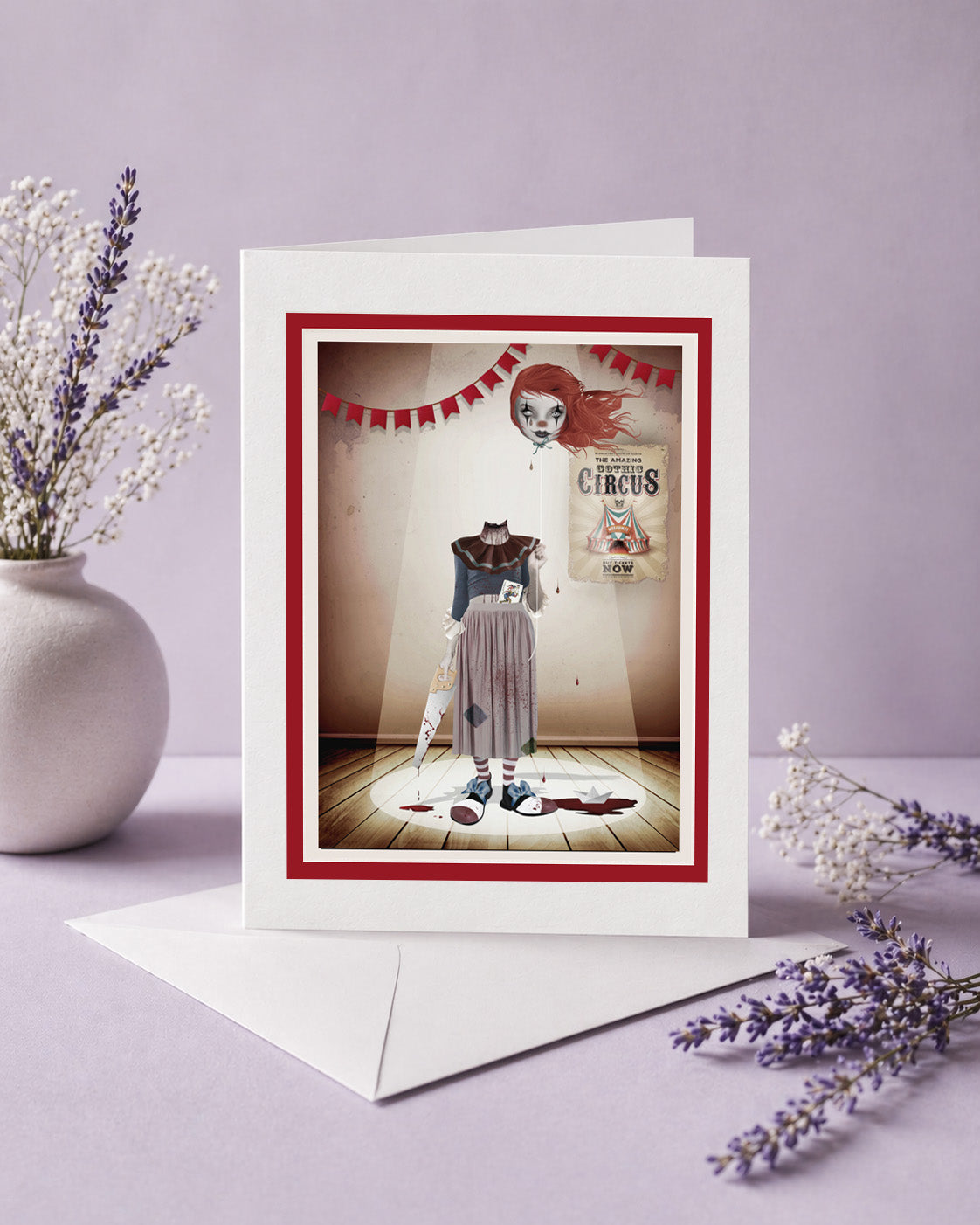 Greeting card with a vintage-style illustration of a headless clown in a circus setting, surrounded by lavender flowers on a light purple background.