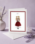 Leo zodiac birthday card featuring an illustration of a blonde maiden with lion ears and a gold crown, wearing a red dress and holding a cat.