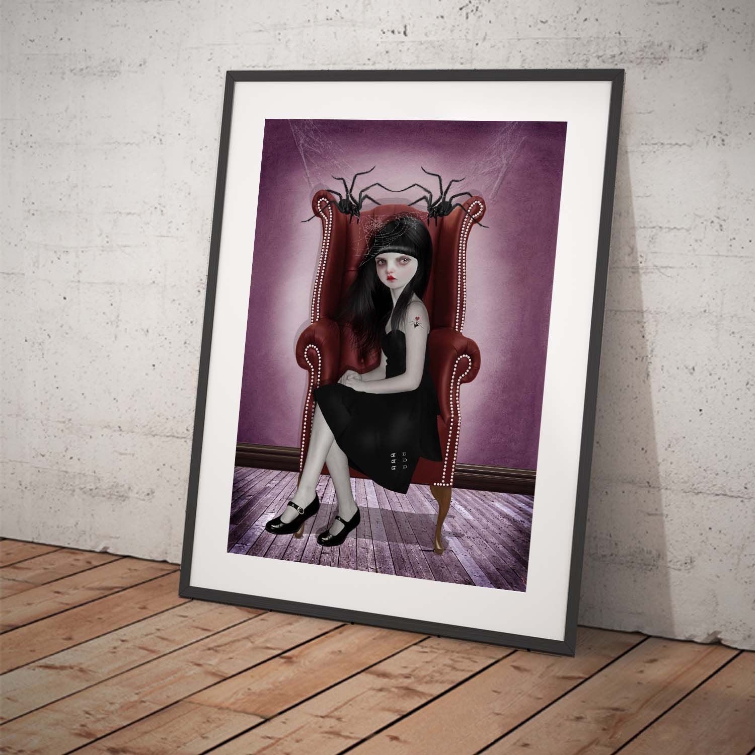 Gothic looking girl named Miss Muffet sitting in between her two enormous pet spiders.