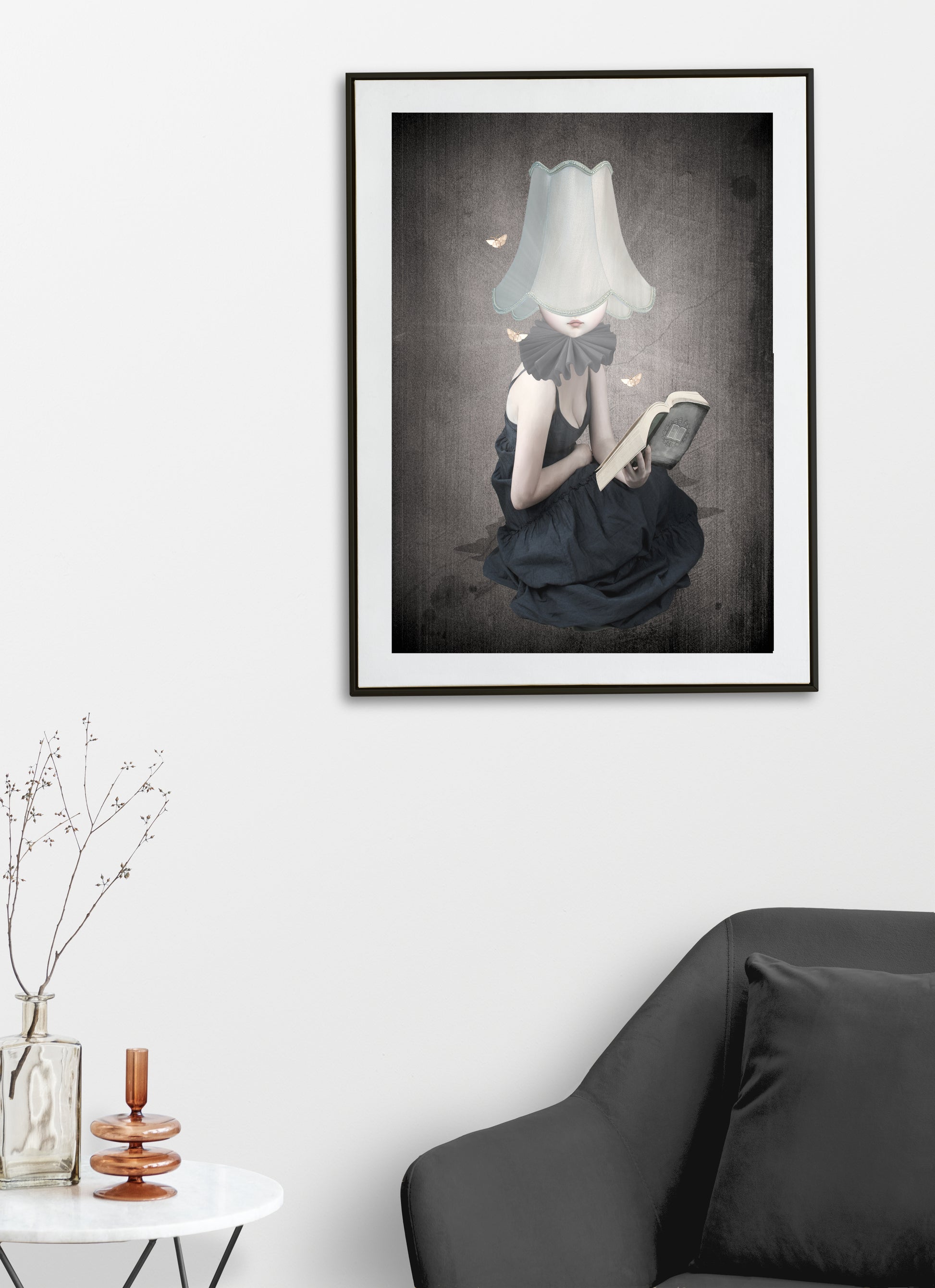 Moth wall  art print framed on living room wall. A young girl, guided by the light of her lampshade, loses herself in the pages of a book. Surrounded by fluttering moths,