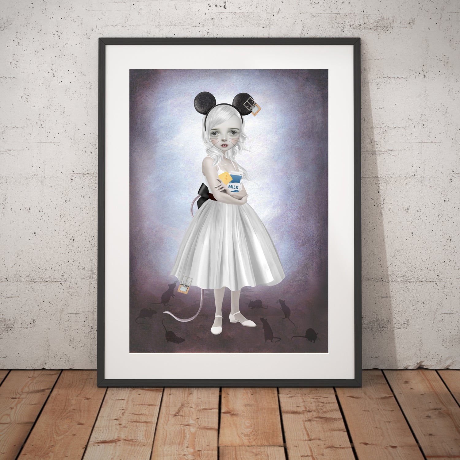 Mouse girl and mice art print in a black frame, standing against a white wall.