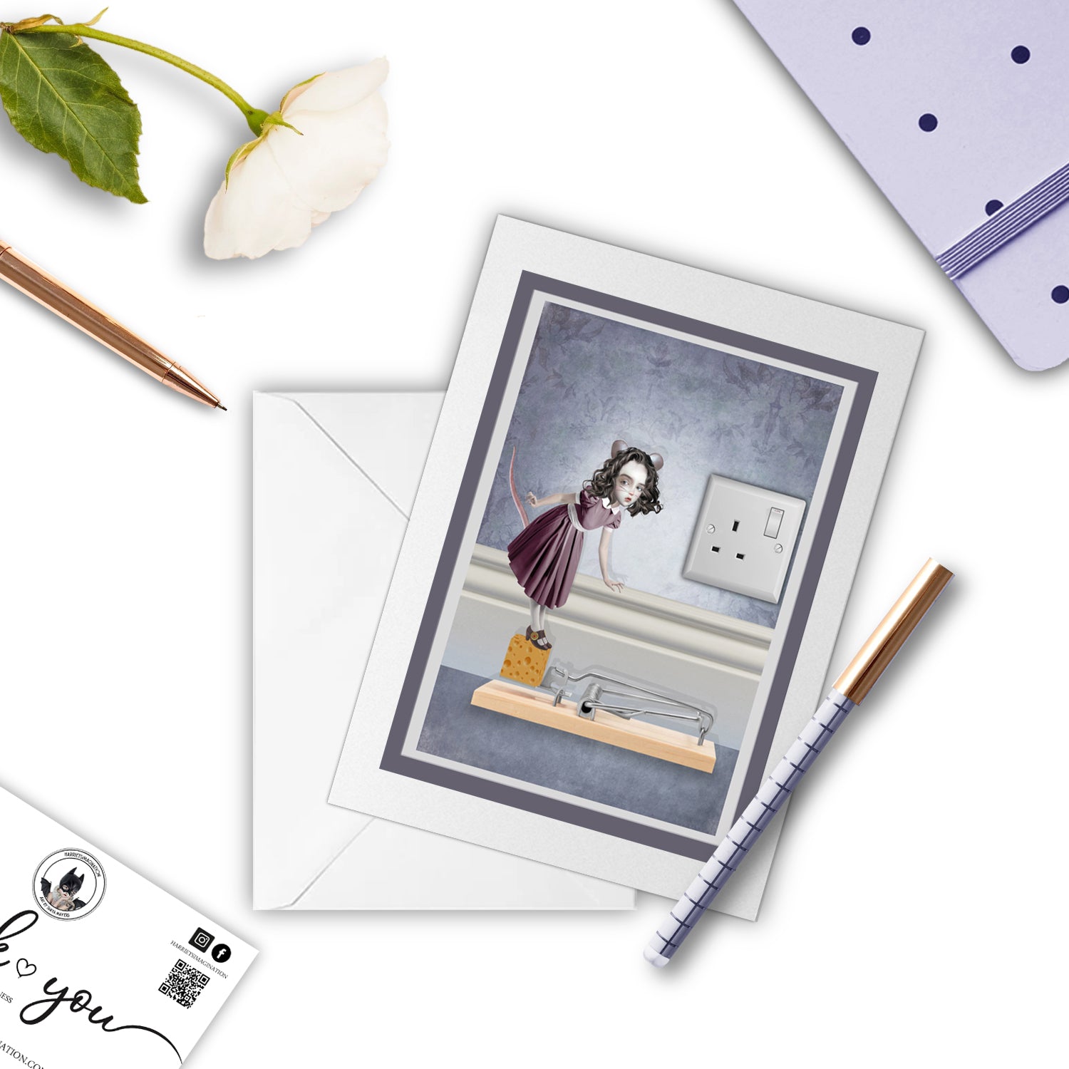 Whimsical Mouse Girl greeting card with blank interior, paired with a notebook and pen for display.