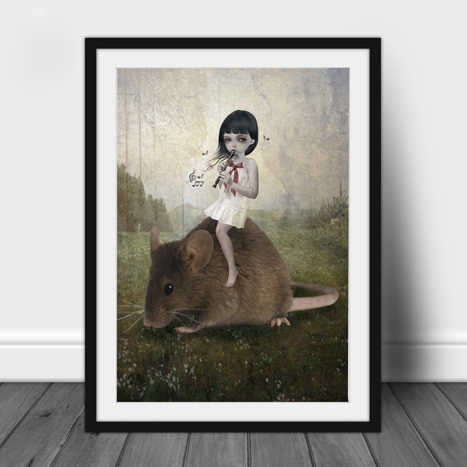Pied Piper art print of a girl playing a flute whilst riding on an oversized mouse, in a frame, leaned against a wall.