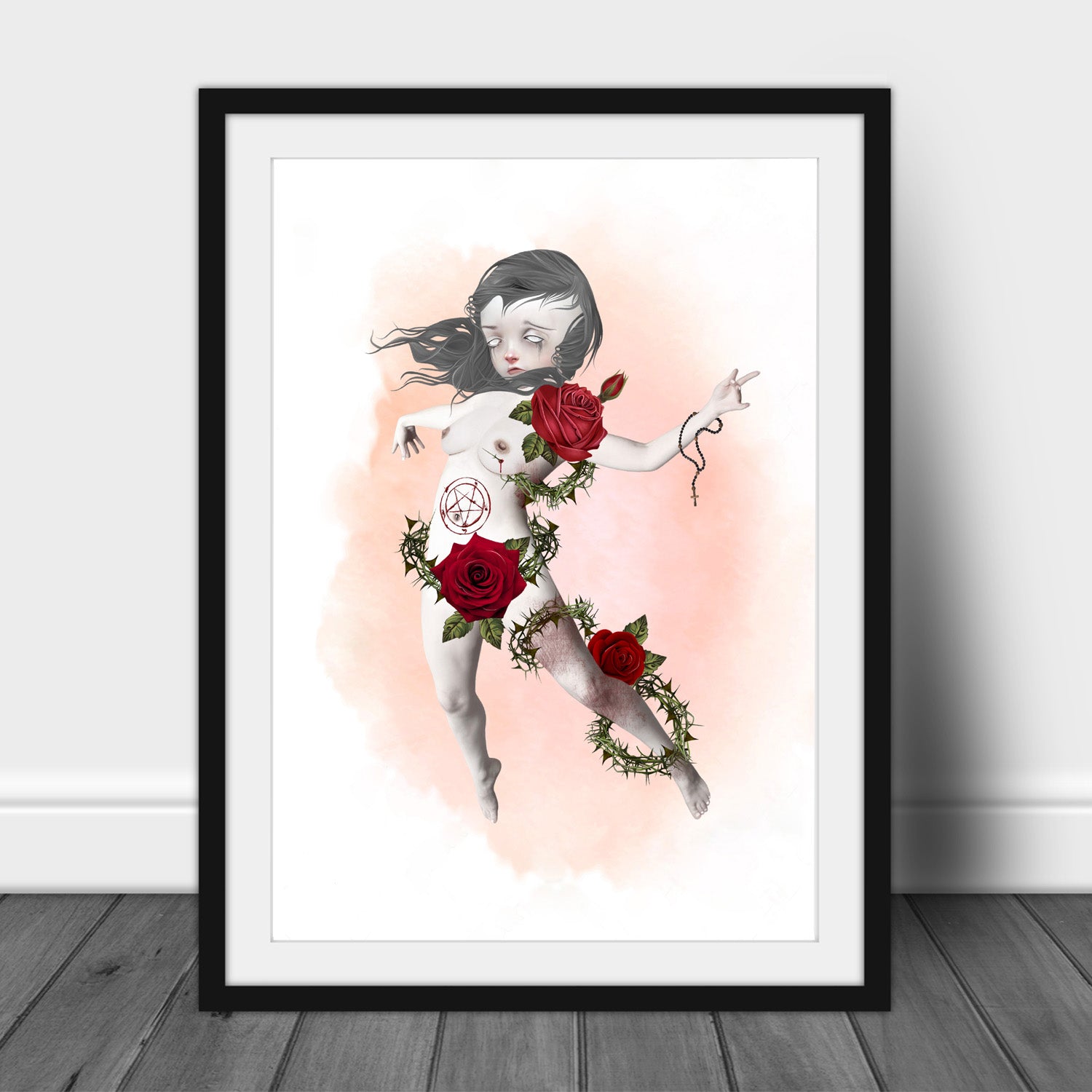 Horror art print of a posessed girl having an exorcism, in a frame, leaned against a wall.