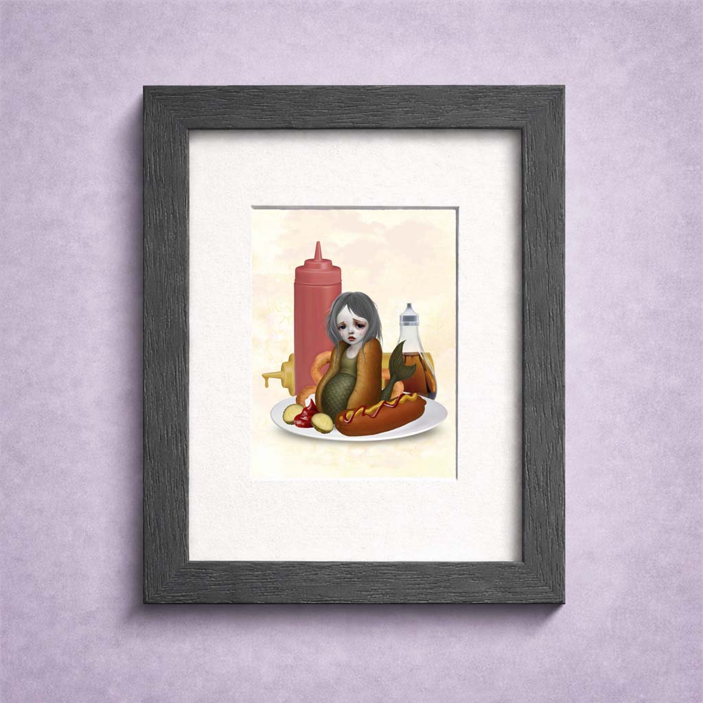 Framed ACEO artwork of a sad mermaid in an hotdog bun on a diners plate, surrounded by sauces.