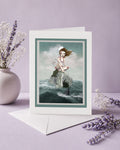 Maritime pop surrealism greeting card features a stranded sailor girl and shark