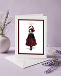 Scorpio zodiac birthday card featuring an illustration of a gothic maiden with dark hair styled into a scorpion tail braid, wearing a black and deep red dress.