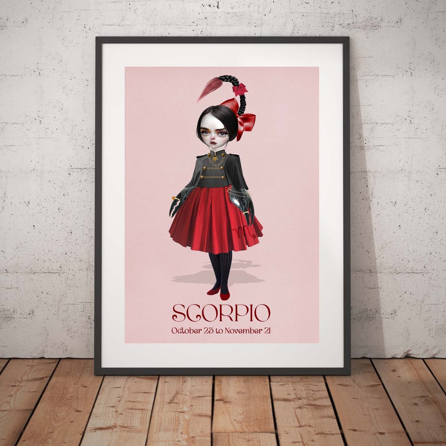 Scorpion girl art print in a black frame, standing against a white wall.