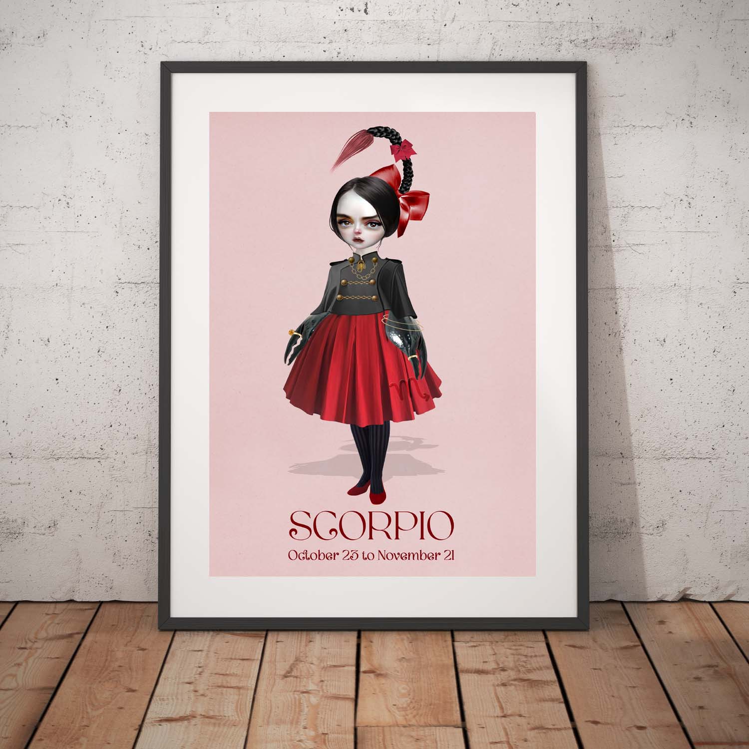 Scorpion girl art print in a black frame, standing against a white wall.