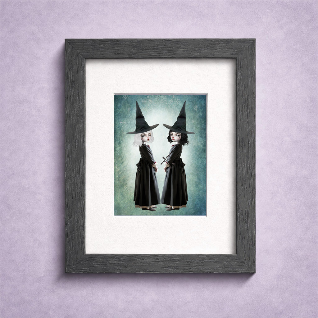 Miniature 2.5x3.5 ACEO art card held in a miniature frame, featuring twin gothic witches with white and black hair against a celestial teal background.