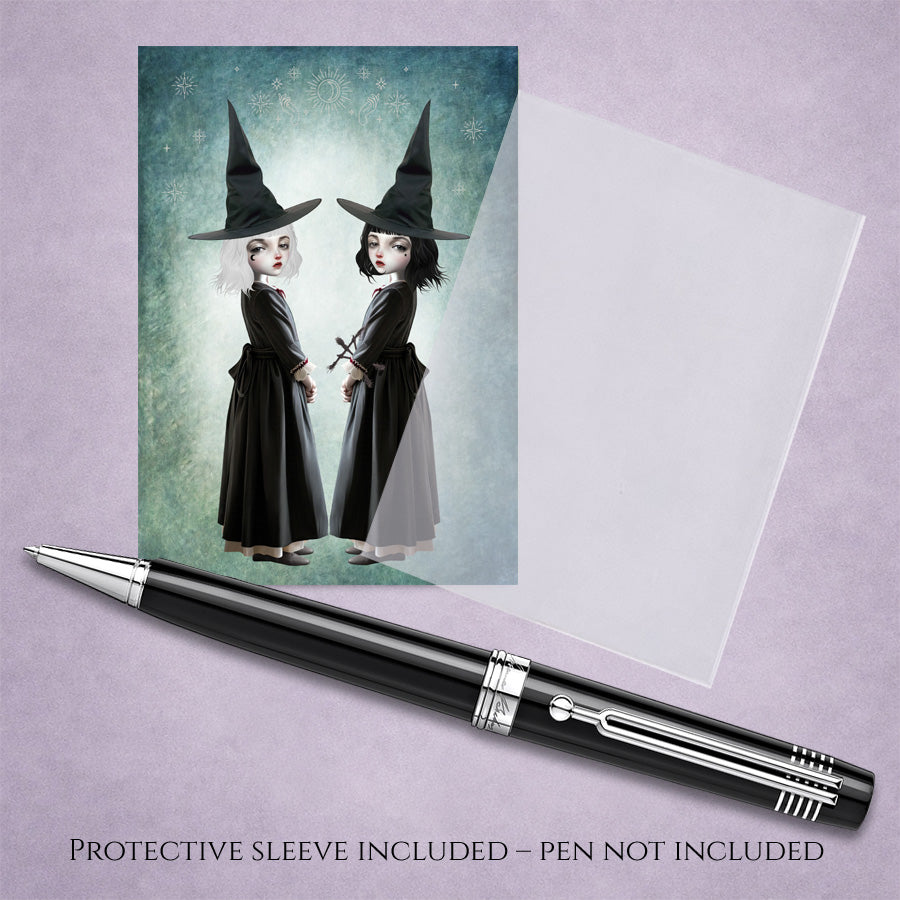 Miniature 2.5x3.5 ACEO art card with protective sleeve, featuring twin gothic witches with white and black hair against a celestial teal background.