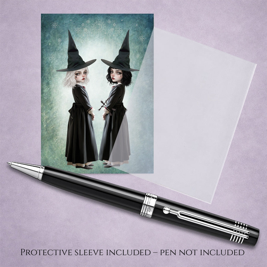 Sister witches ACEO Card and protective sleeve featuring twin gothic witches with white and black hair against a celestial teal background.