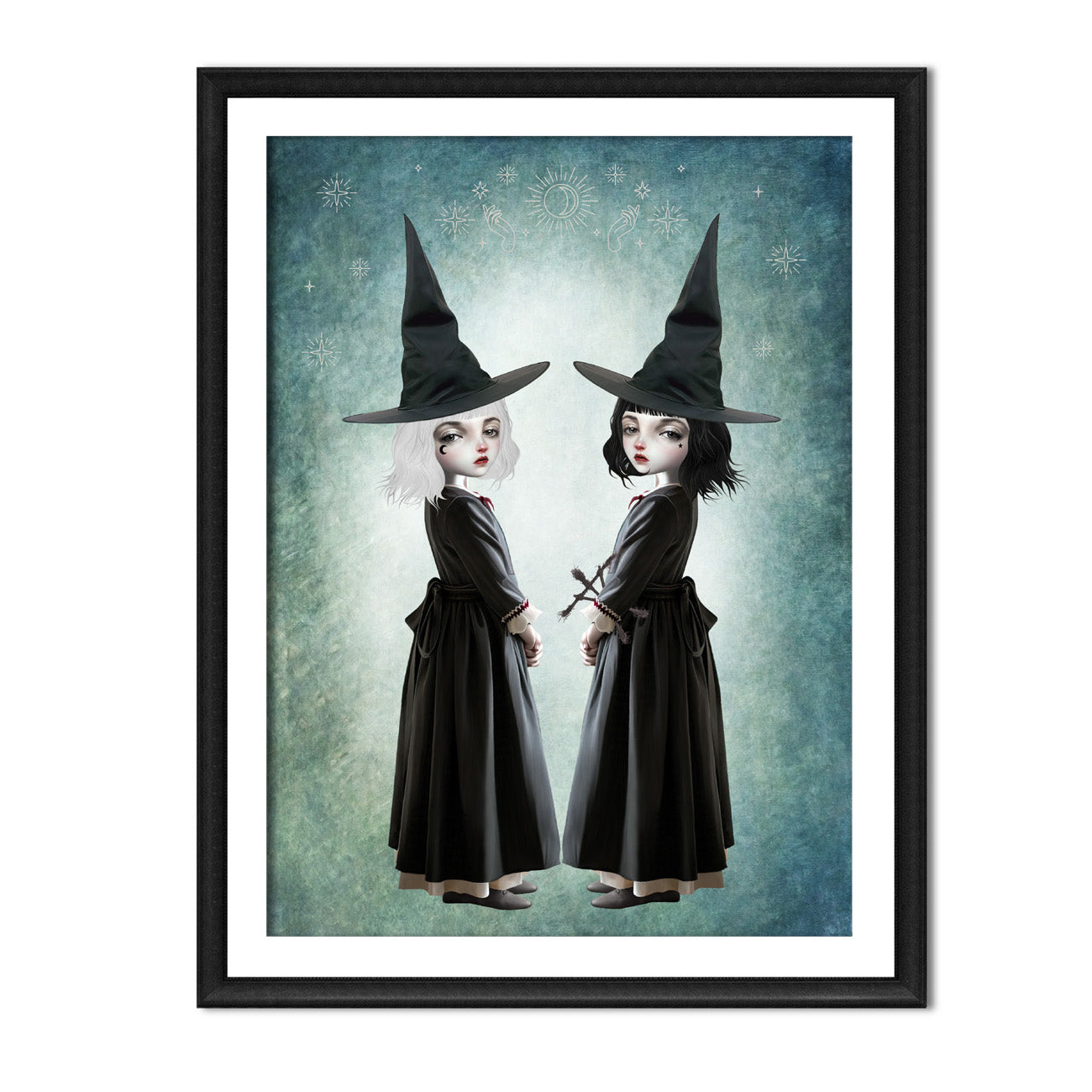 Dark cottagecore fine art print in an A4 frame featuring twin gothic witches with white and black hair wearing pointed hats, set against a celestial teal background.