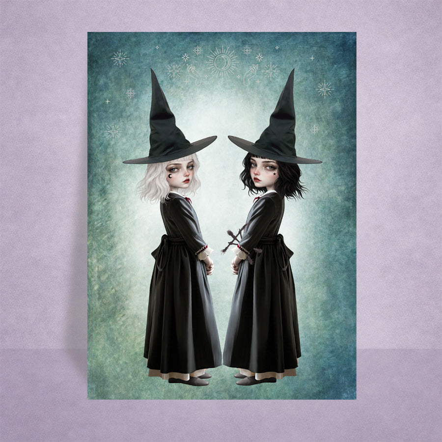 Sister Witches Artist trading card, featuring twin gothic witches with white and black hair against a celestial teal background.