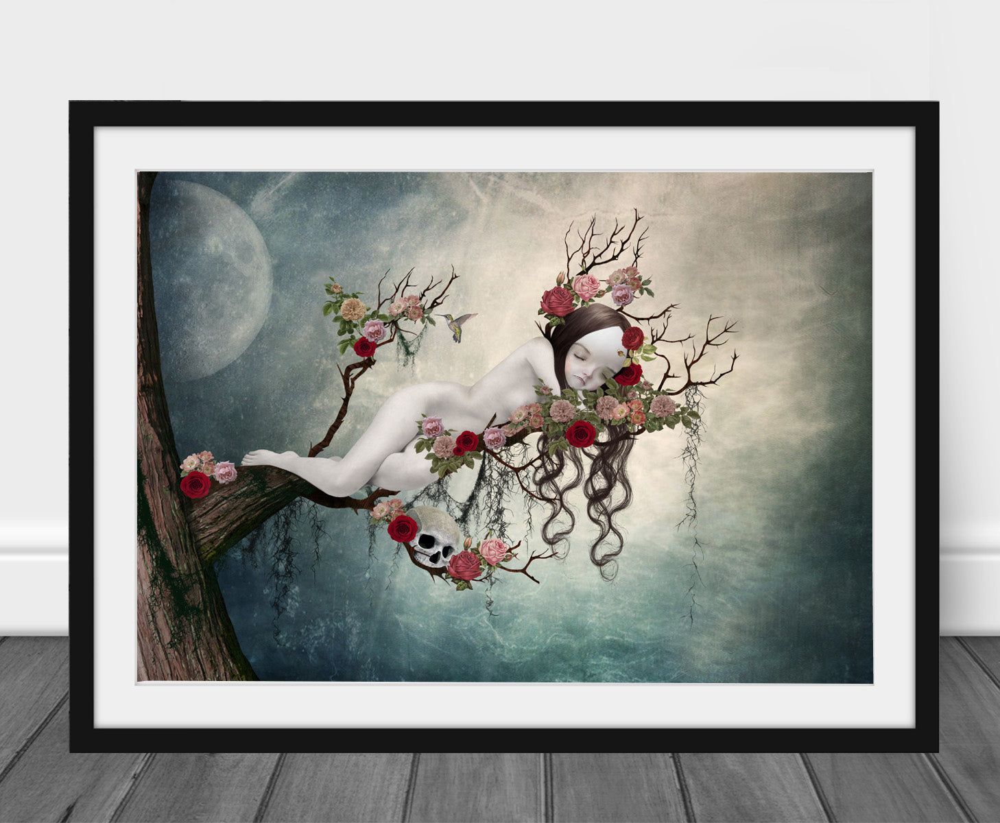 Art print of a sleeping beauty, in a frame, leaned against a wall.