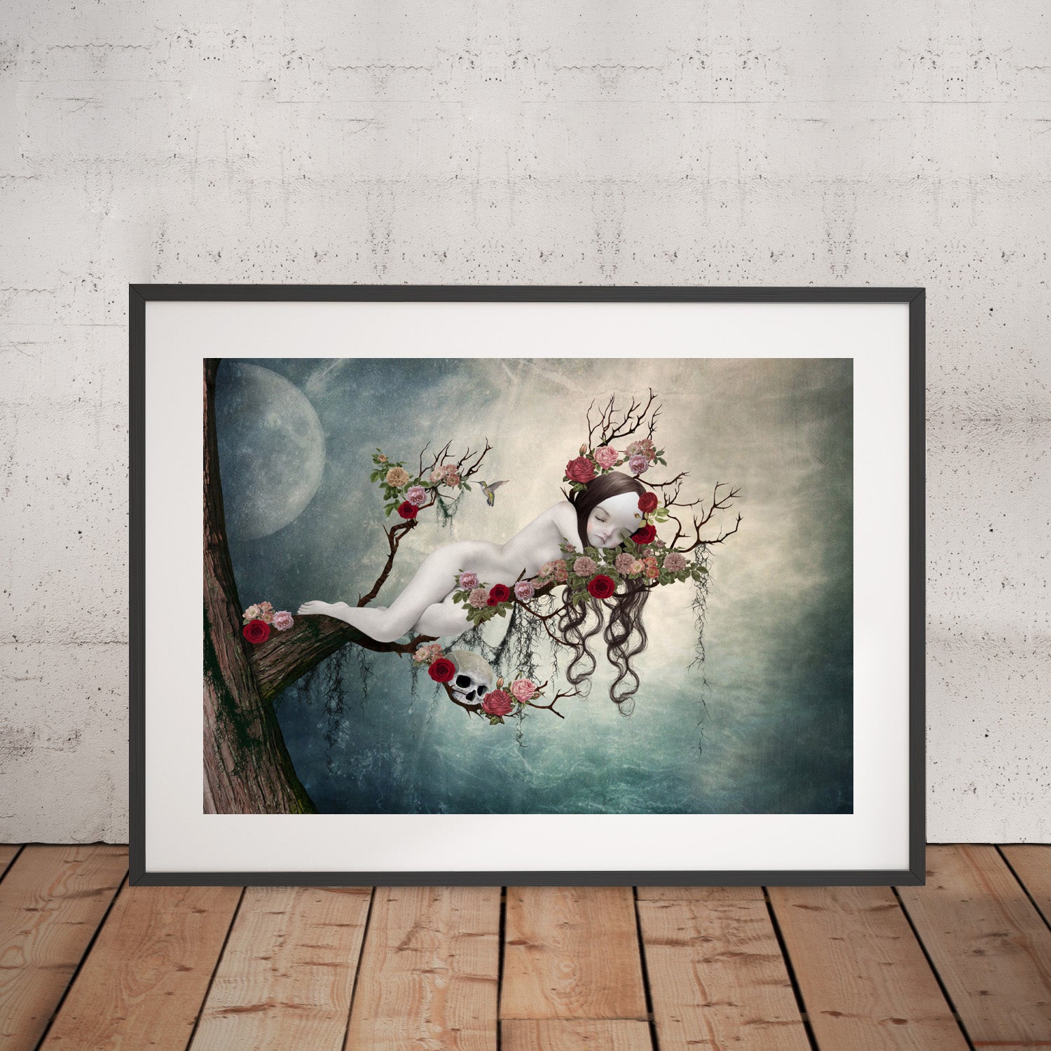 Sleeping Beauty art print in a black frame, standing against a white wall.