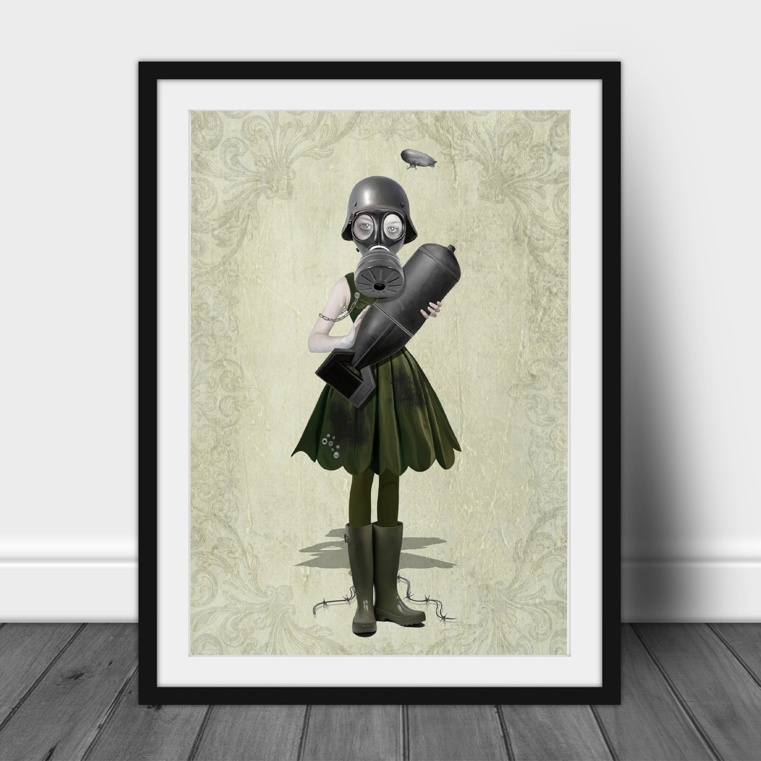 Art print of a soldier girl and bomb, in a frame, leaned against a wall.
