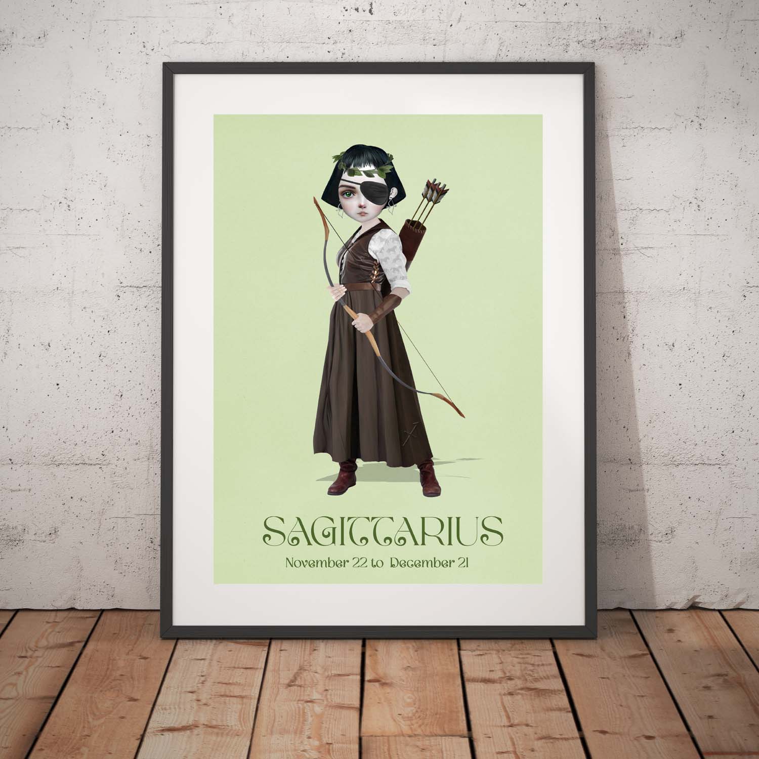 Sagittarius Girl art print in a black frame, standing against a white wall.