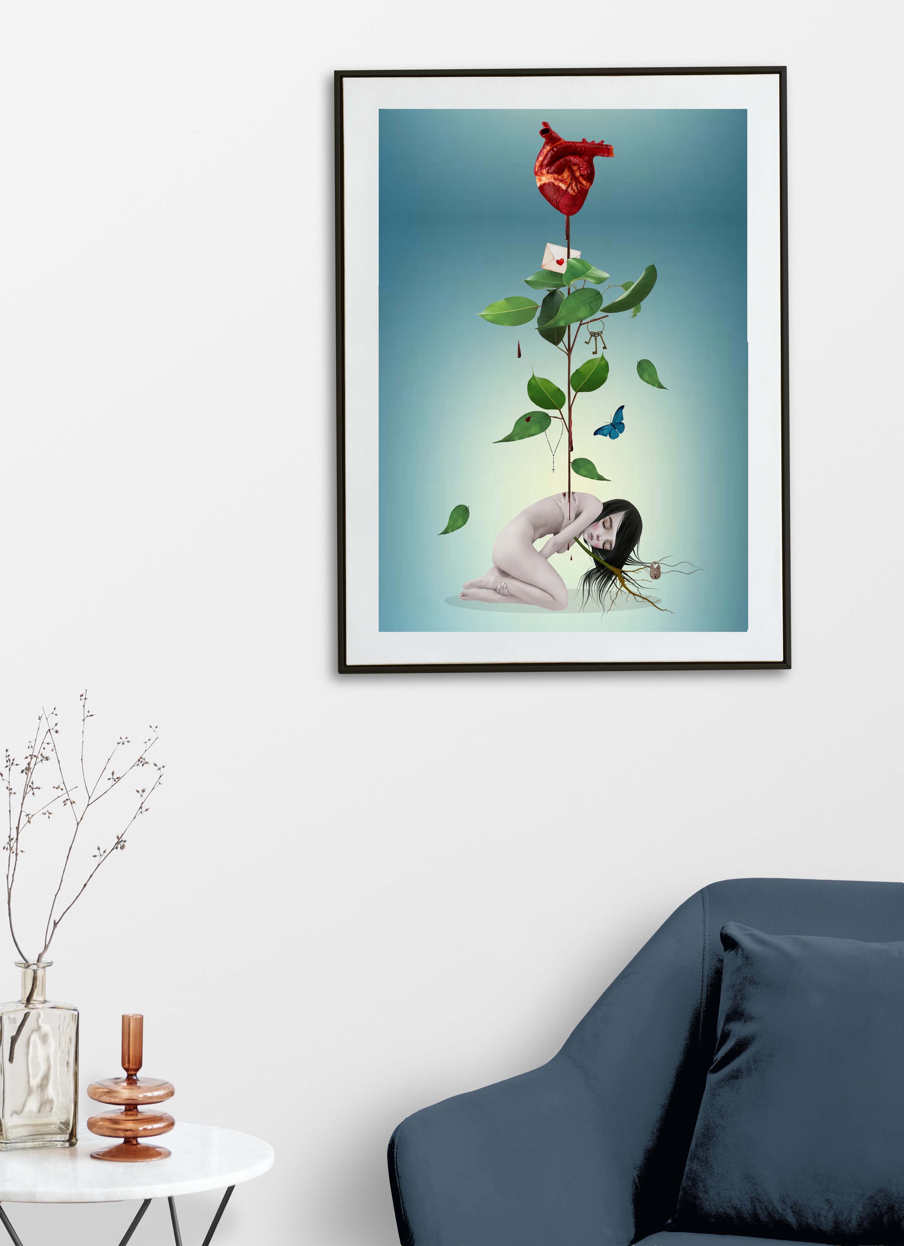 Framed surreal anatomical heart and botanical gothic artwork displayed above a blue chair in a modern minimalist living room interior.