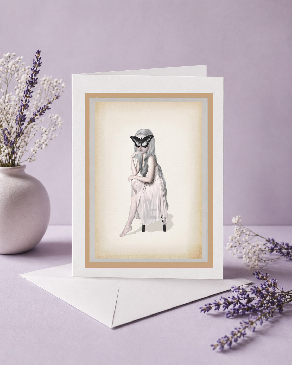 Greeting card with an illustration of a woman with oversized butterfly on her face.