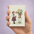 Surreal ACEO art card of a girl tending to a potted plant where vibrant dandelions transform into roaring and sleeping lions.