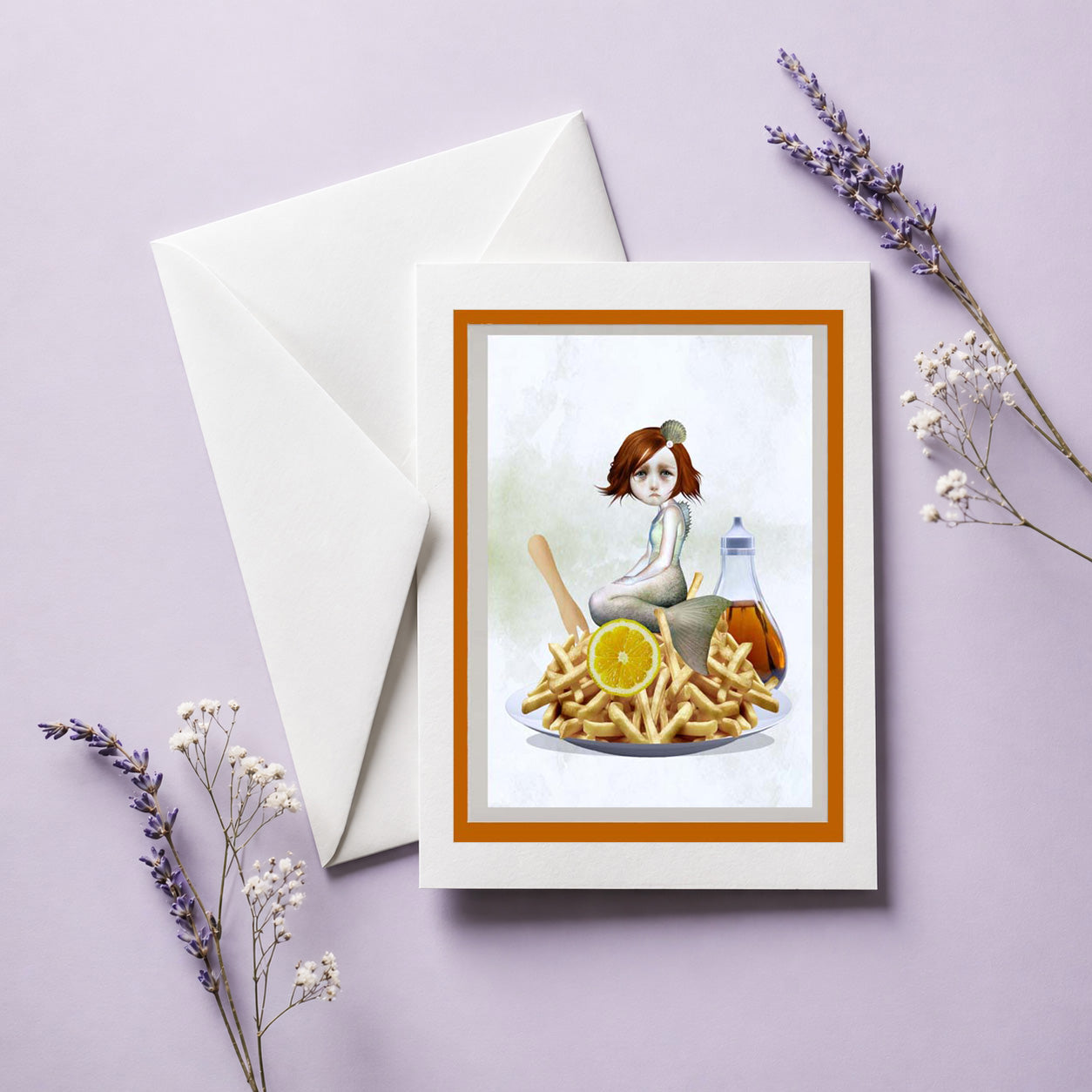 Art greeting card with illustration of a sad mermaid sitting on a plate of fries, accompanied by an envelope and decorative elements on a light purple background.