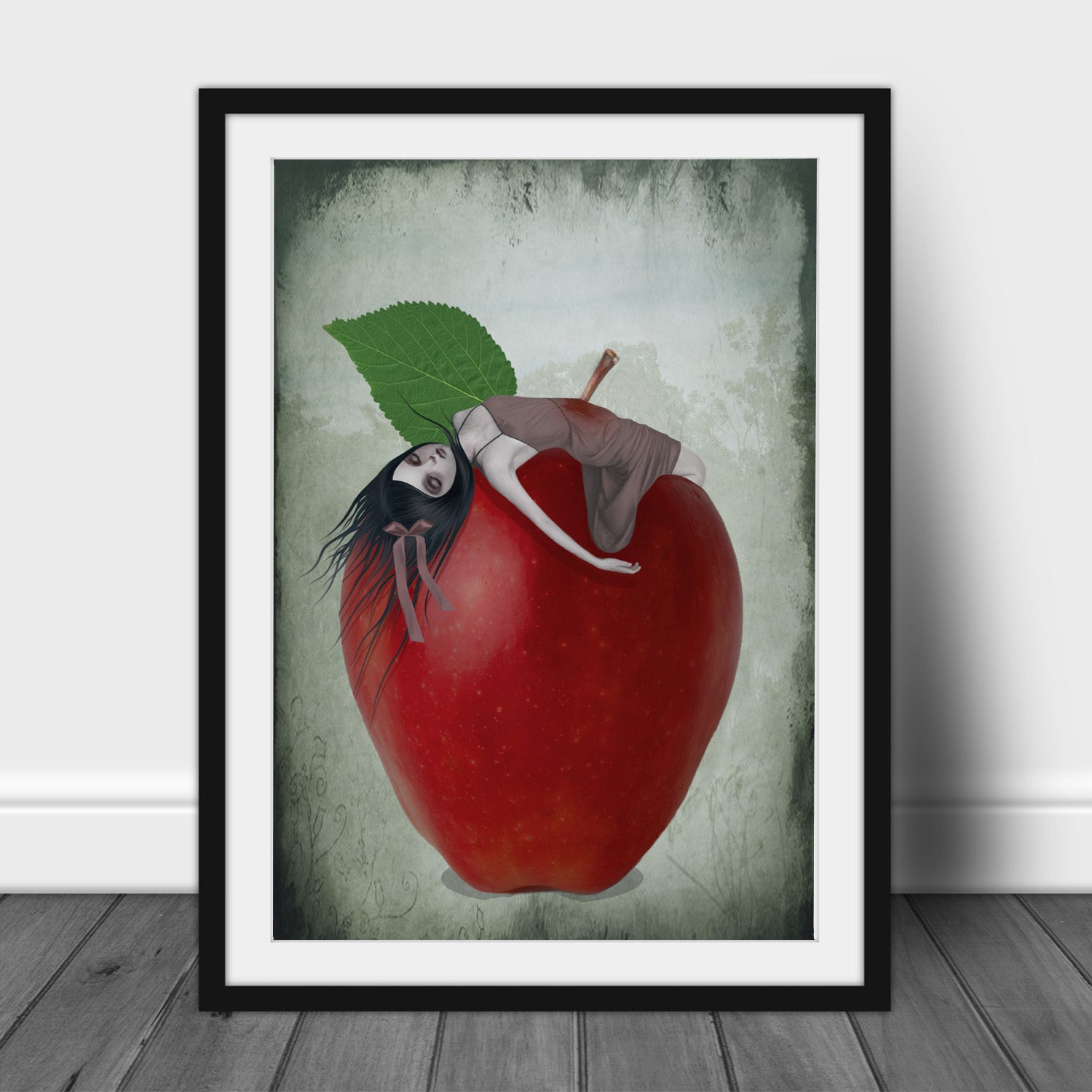 Framed Surreal Red Apple Art Print against a white wall.