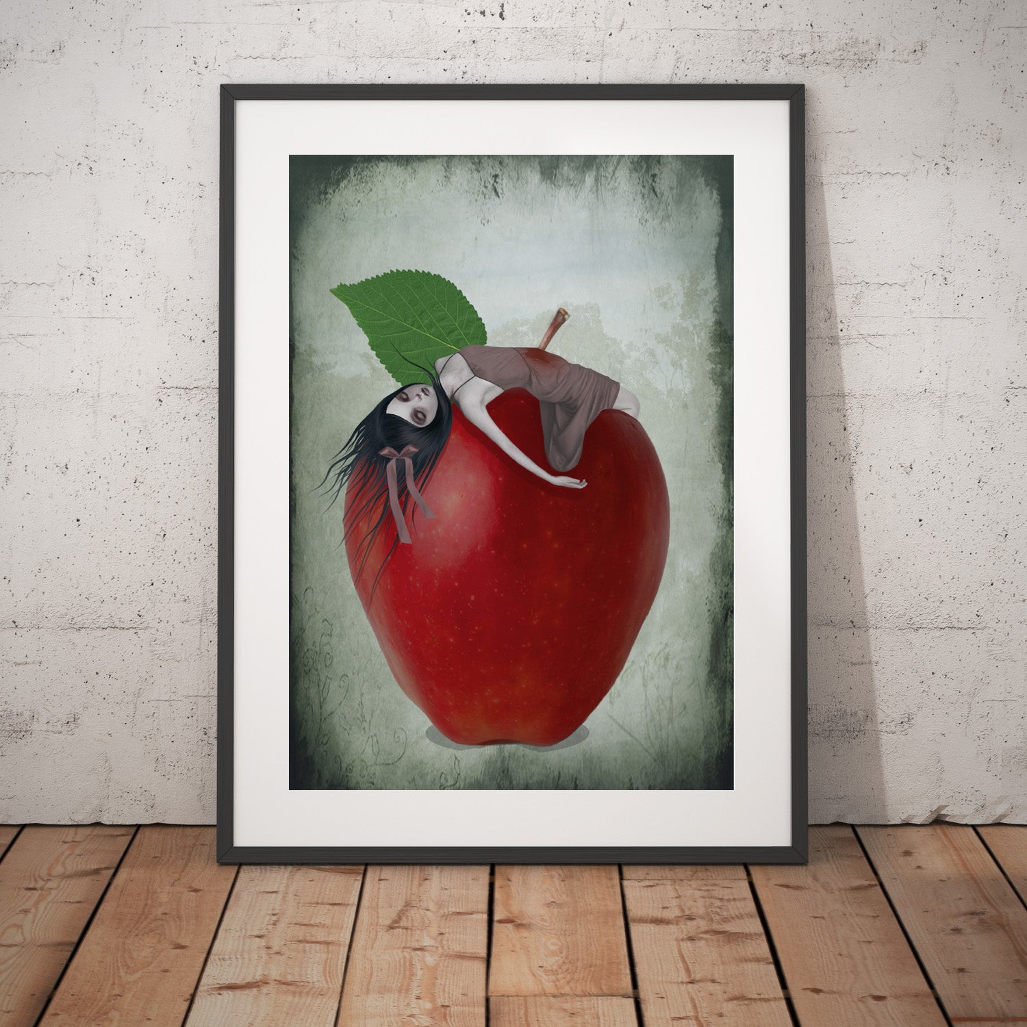 Surreal Red Apple Art Print leaning on a white wall.