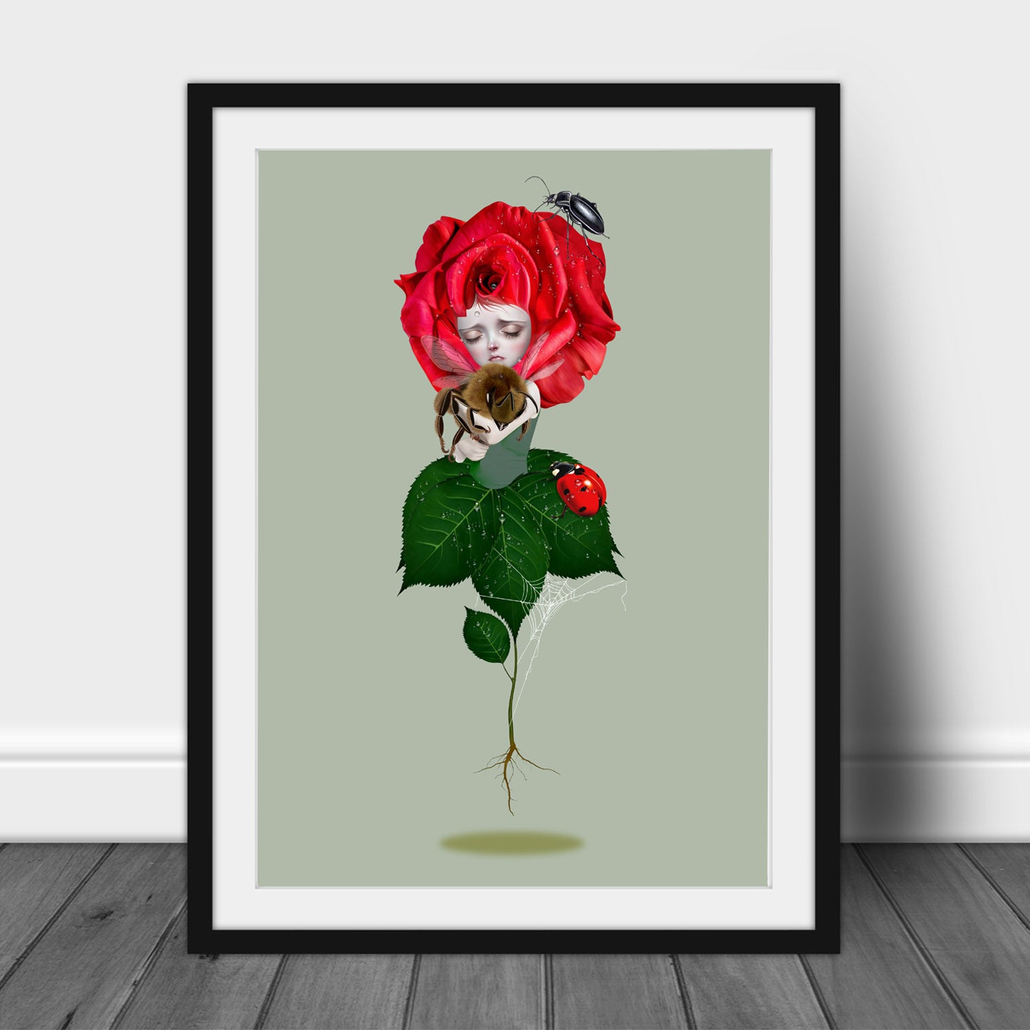 Framed A3 art print illustration is a bee emerging from the heart of a vibrant red rose, surrounded by enchanting garden companions including a bee, ladybird, beetle, and intricate spider's web.