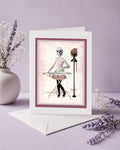 Greeting card with skeleton girl design on a purple background with lavender flowers.