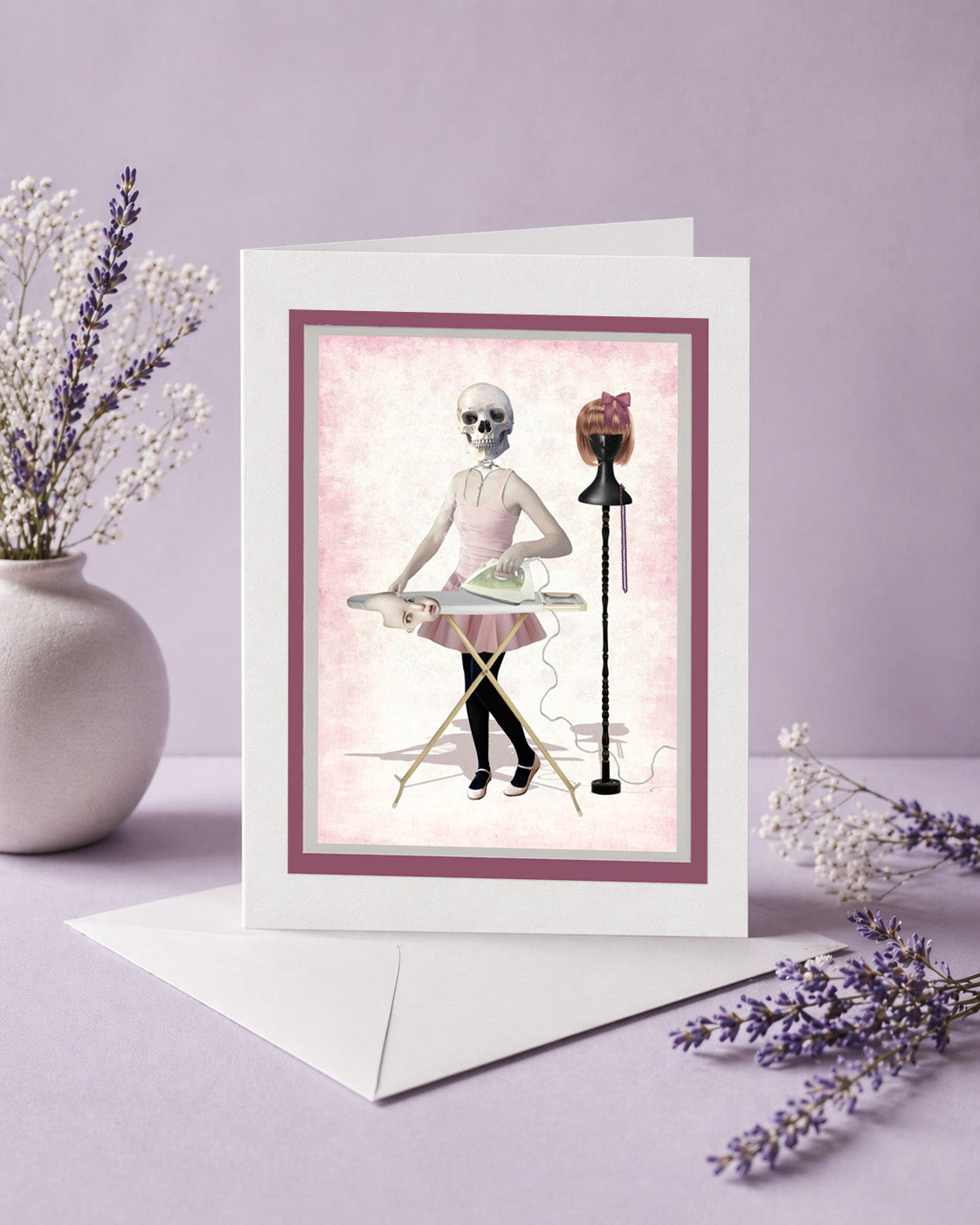 Greeting card with skeleton girl design on a purple background with lavender flowers.
