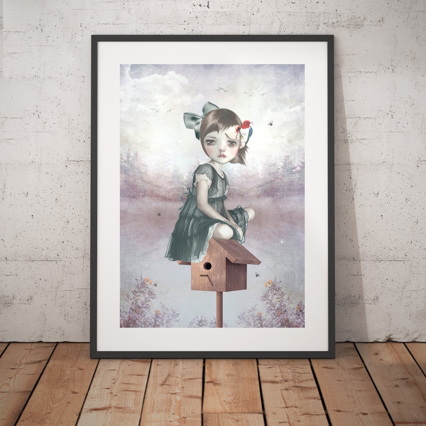 Surreal art print framed and placed against a wall, depicting a girl sitting on a birdhouse with a woodpecker pecking her head, blending whimsy and fantasy.