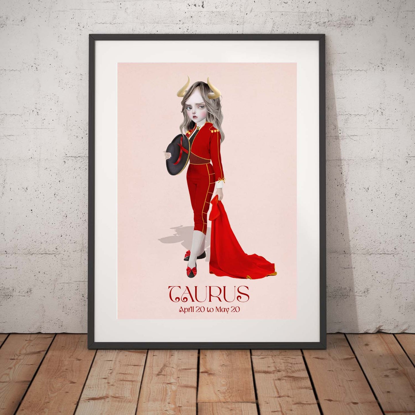 Taurus girl star sign art print in a black frame, standing against a white wall.