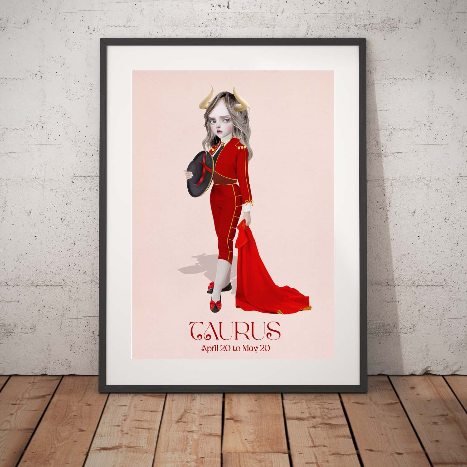 Taurus girl star sign art print in a black frame, standing against a white wall.