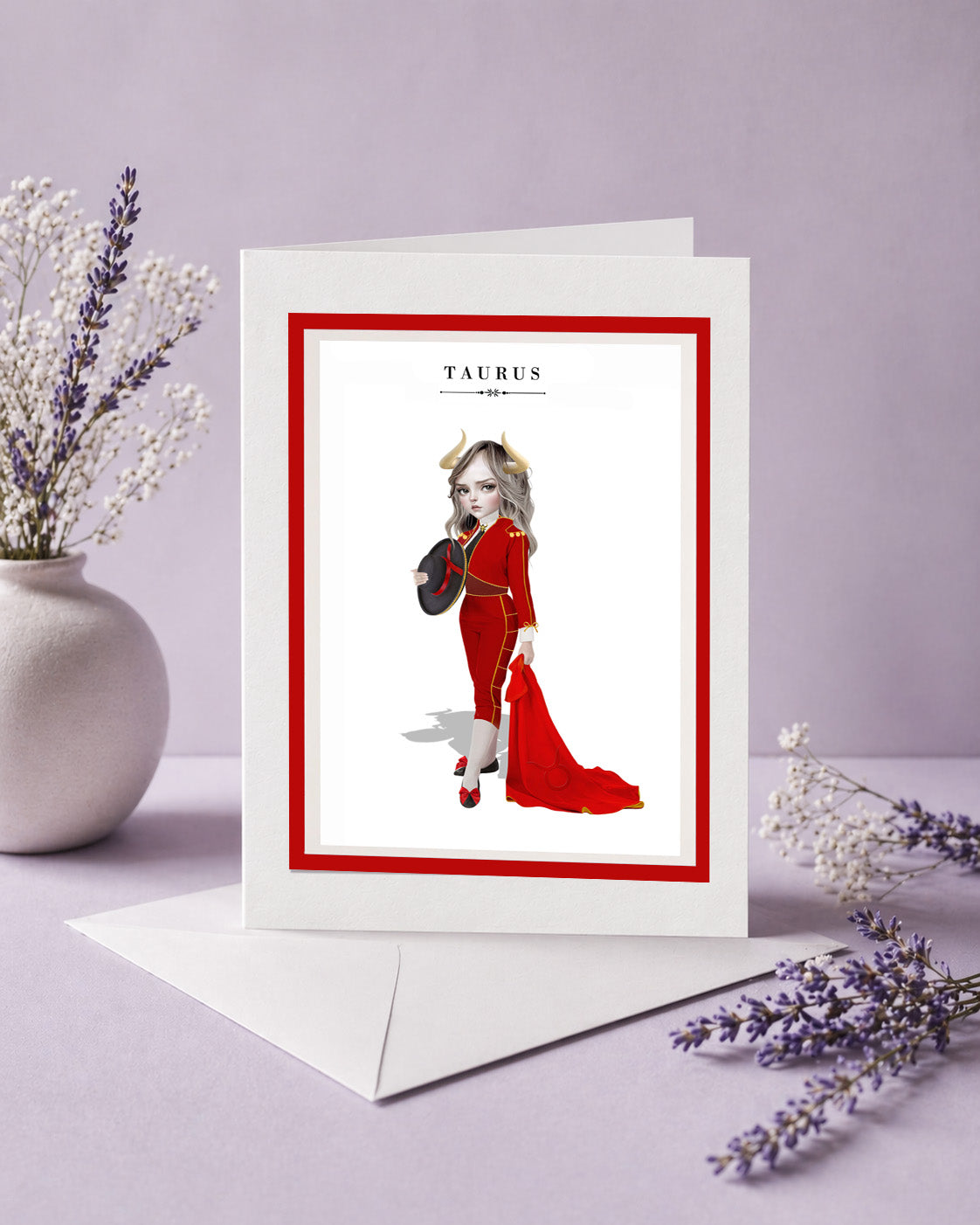 Taurus zodiac birthday card featuring an illustration of a horned maiden in a red matador suit holding a red cape and hat.