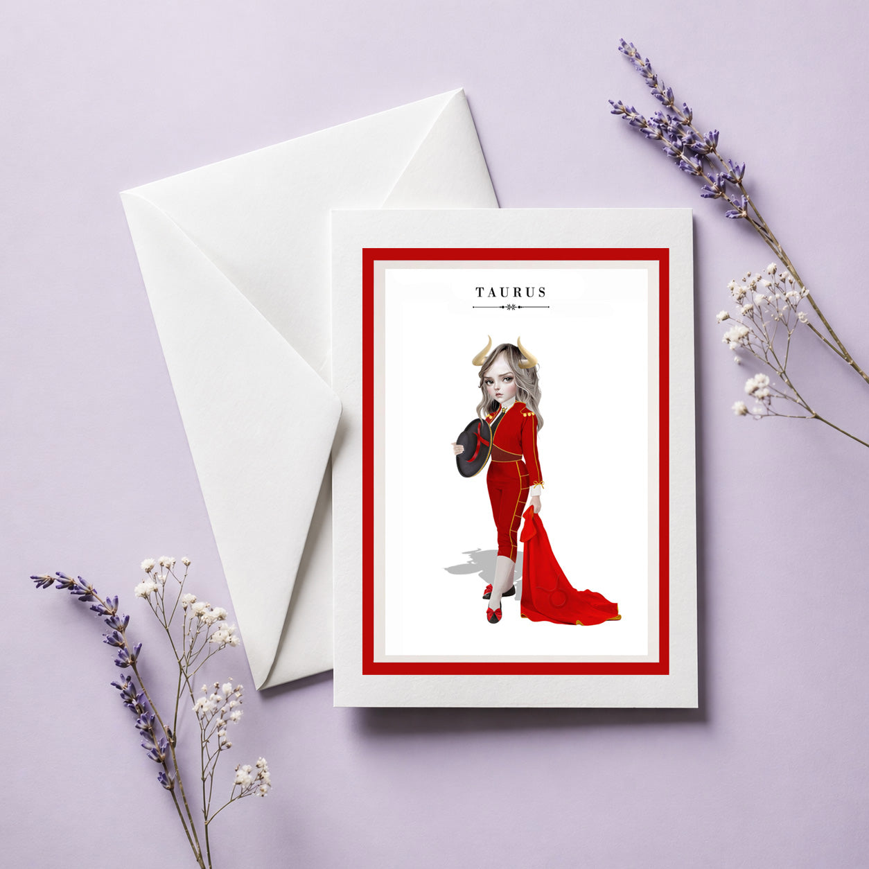 Taurus zodiac birthday card and envelope featuring an illustration of a horned maiden in a red matador suit holding a red cape and hat.