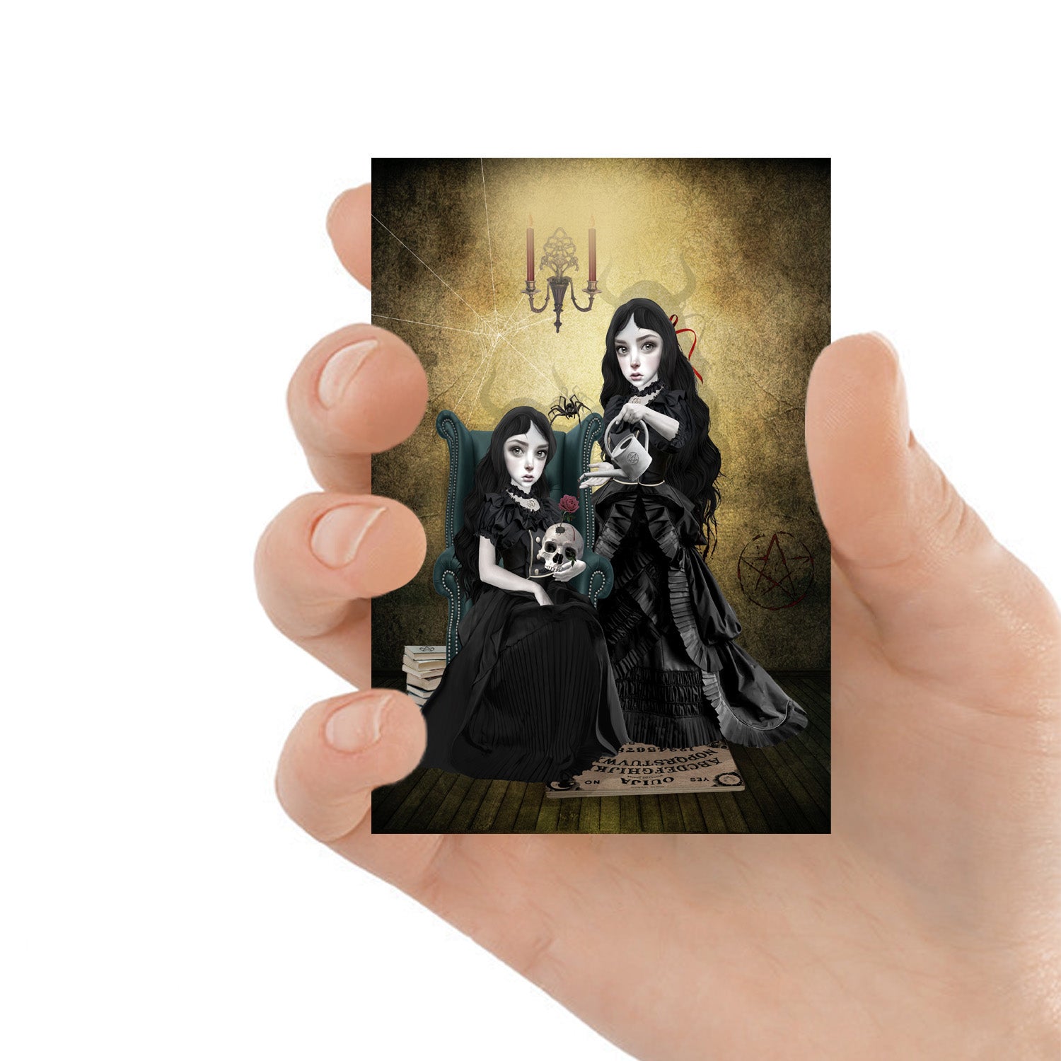 ACEO art card featuring two sister witches preparing for the witching hour, held in hand—creepy cute gothic art style with dark, witchy elements.