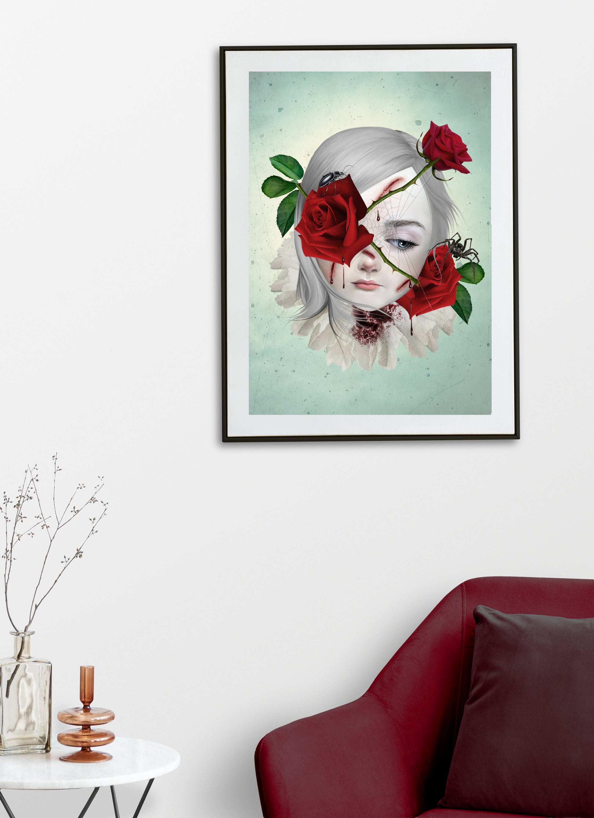 Surreal art print of a girl with thorny red roses bleeding from the thorns, surrounded by a spider and beetle, framed in black and hanging on a modern living room wall. This dark fantasy piece adds depth and emotional intensity to any space.
