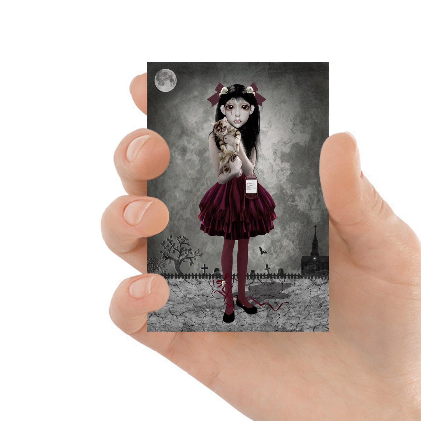 ACEO art card featuring a vampire girl with cat, held in hand to showcase the miniature size and creepy cute design.