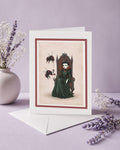 Premium art greeting card featuring a gothic vampire queen on a throne with large red and black bumblebees, blank inside and designed ready to frame.