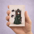 ACEO miniature gothic art print held in hand features a dark-haired vampire queen on a throne with large red-and-black bumblebees pouring blood from a goblet.