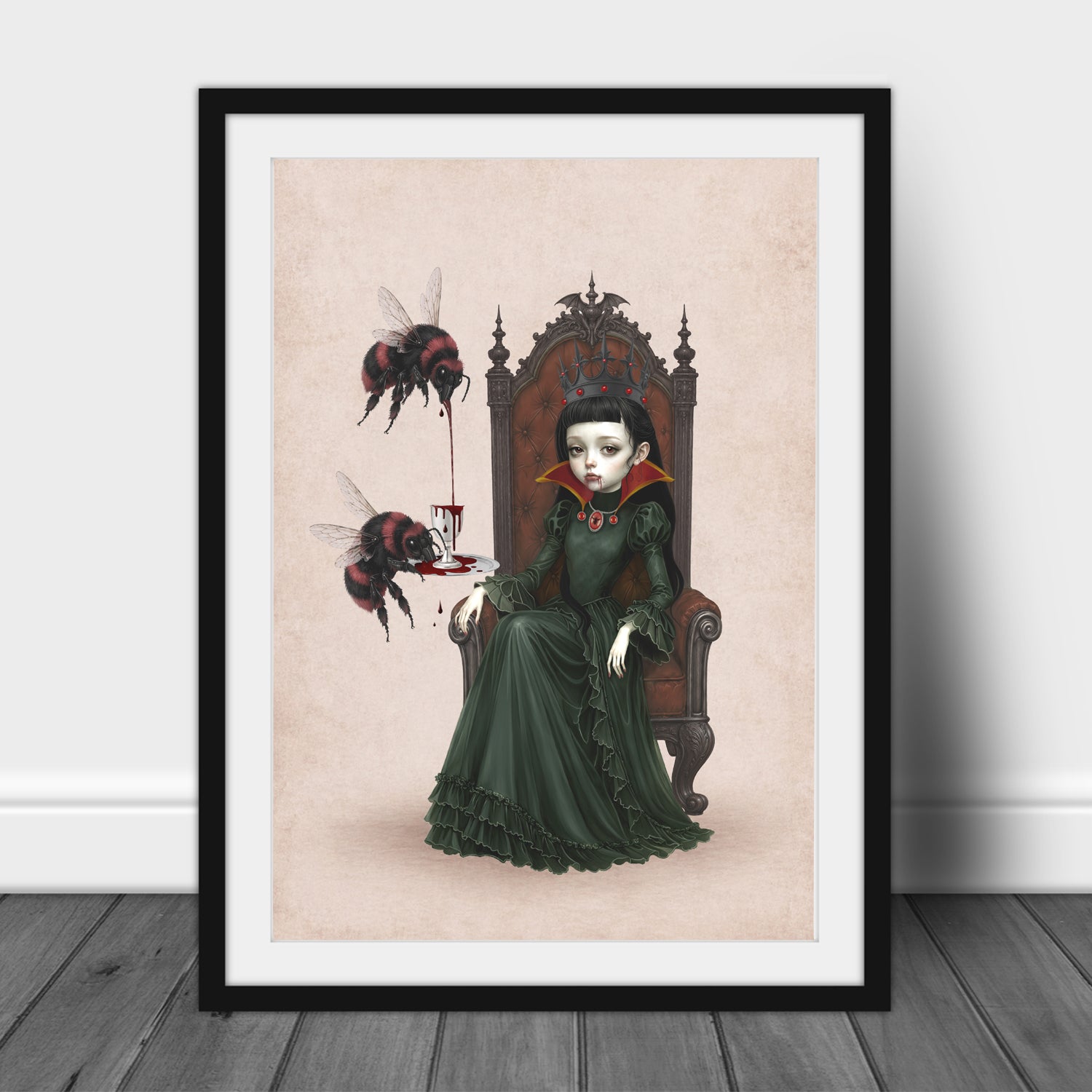 Gothic pop surrealism art print in an A3 frame featuring a vampire queen with a black crown sitting on a throne, with two large red-and-black bumblebees pouring blood from a goblet.