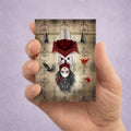 Hand holding ACEO Card featuring a vampire girl hanging friom the belfry with her bats.