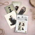 Victorian goth postcard set, each piece captures a solitary soul navigating a surreal, quiet world—whether they're finding peace resting in a silk-lined coffin, tending to a perilous Venus flytrap, sharing tea time with a few giant sugar ants, or literally knitting a storm cloud to pass the time.