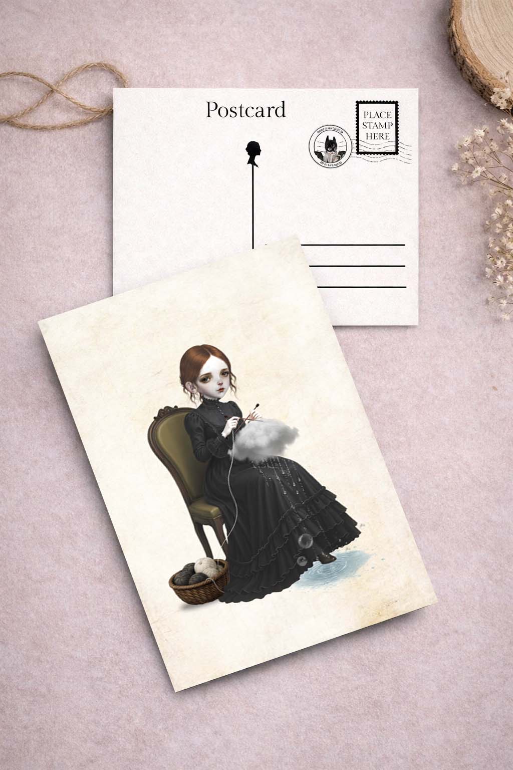 Postcard with an  illustration of a Victorian woman sitting in a chair knitting a rain cloud on a textured surface.