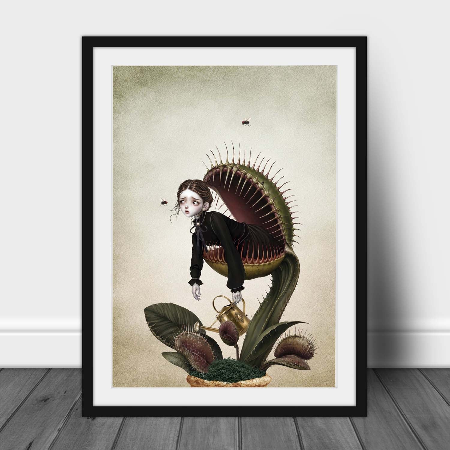 A dark whimsy Victorian gothic A3 framed art print of a melancholy Victorian woman trapped inside a giant potting-pot Venus flytrap carnivorous plant while holding a vintage gold watering can.