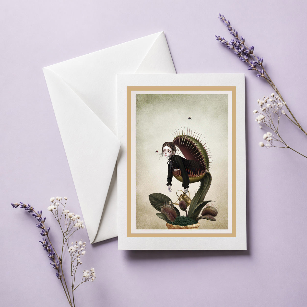 Art greeting card with envelope featuring a Victorian gothic illustration of a girl inside a Venus flytrap, displayed upright on its white envelope next to a small ceramic vase with dried lavender and baby's breath flowers on a light purple background.