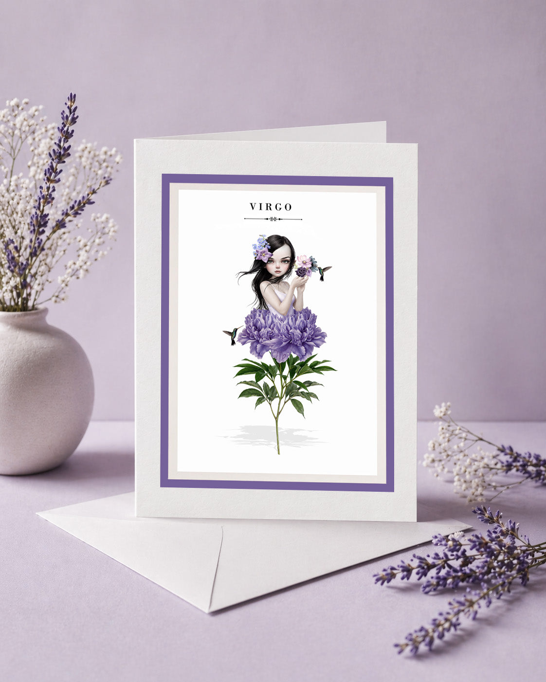 Virgo zodiac birthday card and envelope with an illustration of a dark-haired maiden emerging from a large purple peony flower, holding a violet rose with hummingbirds.